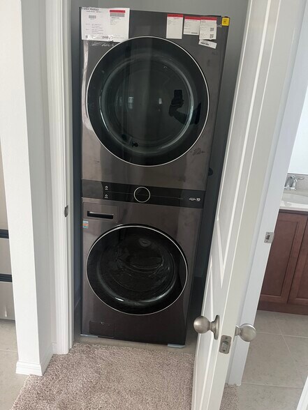 Stacked washer and dryer included in unit. - 6436 Rover Way
