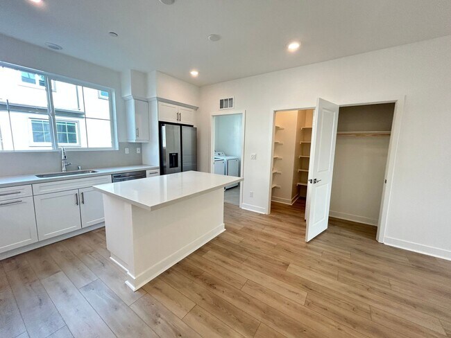 Building Photo - Gorgeous, 3 level townhome, featuring 2 car garage central Air, and in Unit laundry.
