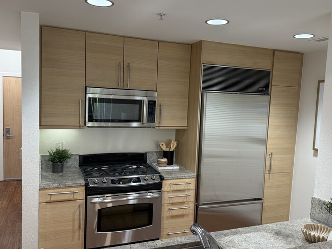 A fully equipped kitchen featuring premium appliances, including a state-of-the-art Sub-Zero refrige - 1655 N California Blvd