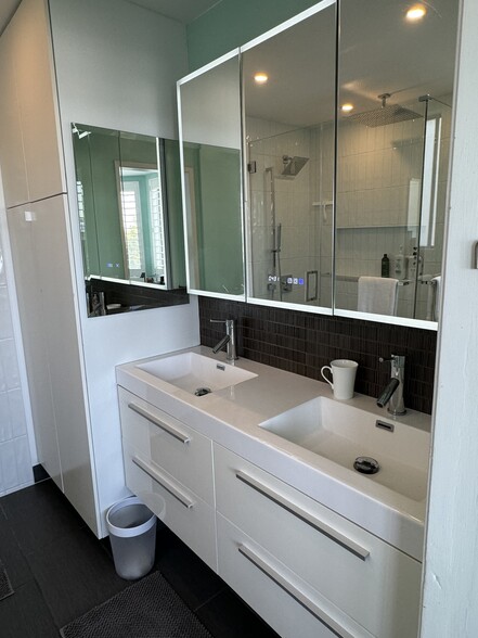 Double sink with modern vanity with time, temperature, anti-fog, and plug-ins - 8530 Holloway Dr