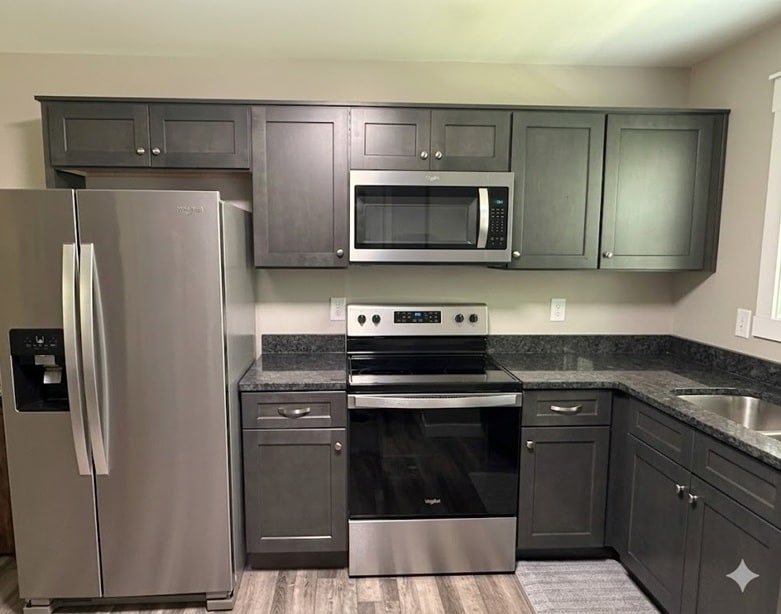 Modern kitchen with granite countertops and stinless steel appliances - 111 Buster Ln