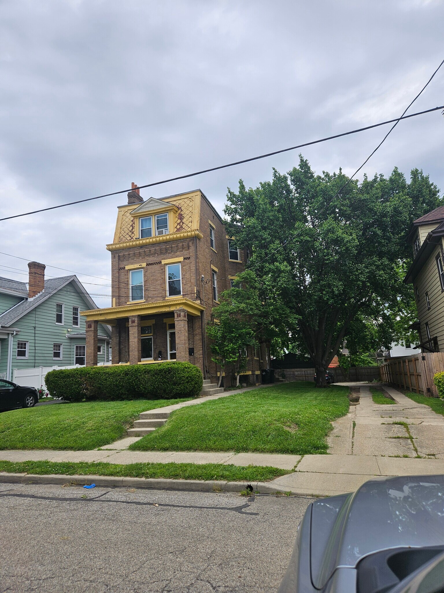 Front of home with driveway. There are 3 parking spaces in back, one for each unit. - 3914 S Madison Ave