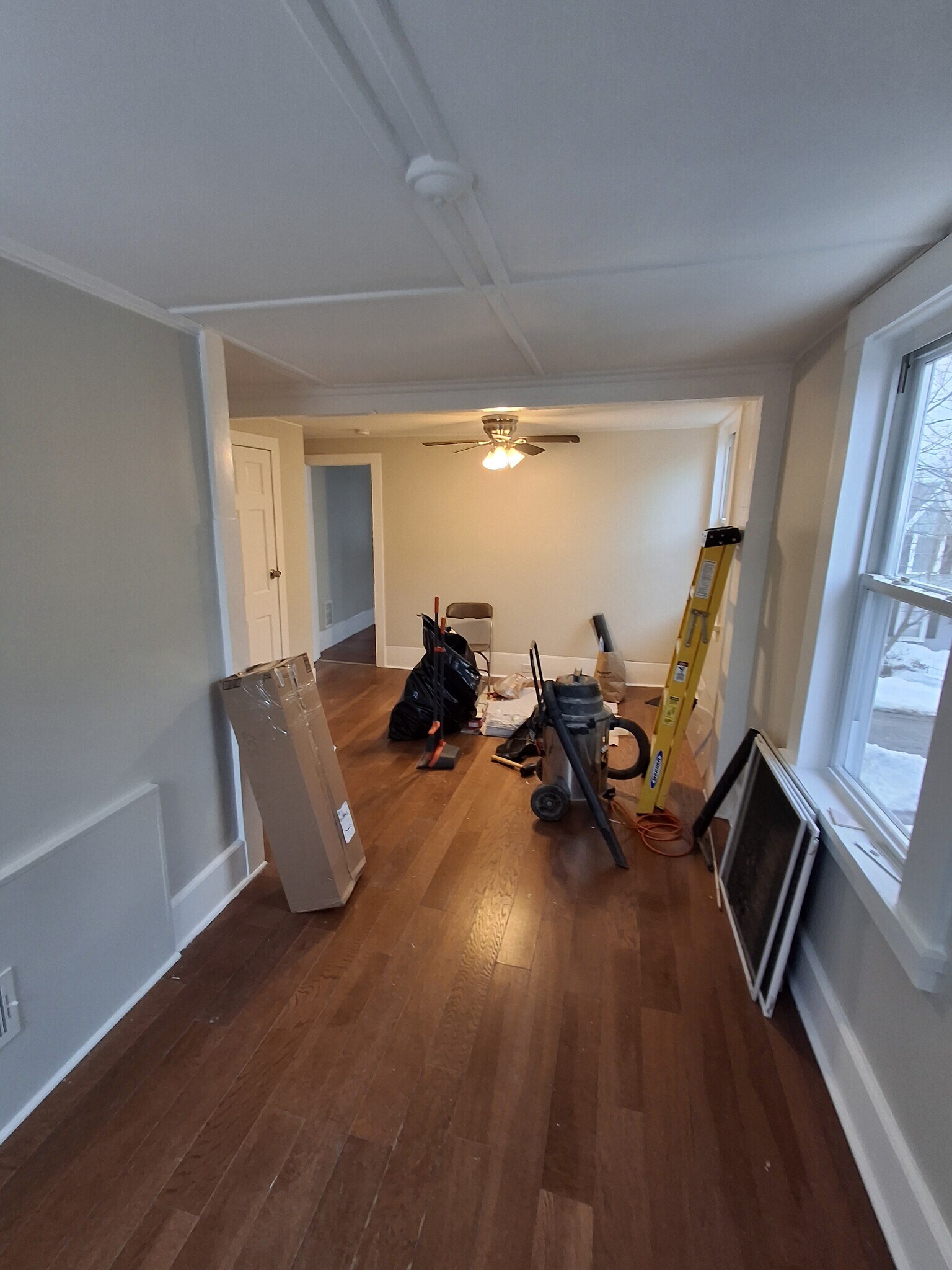 Living Room: Ceiling fan, laminate flooring, and a closet (left in photo). Excuse the mess! - 13 Mulberry St