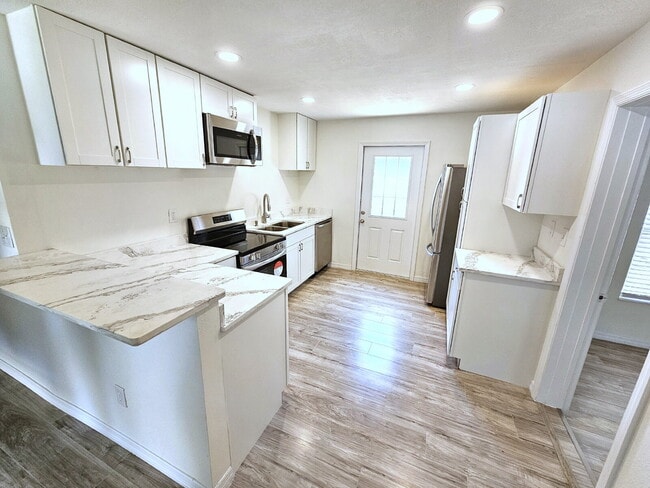 Building Photo - fully renovated 2-bedroom, 1-bathroom home with bonus guest room or office and oversized fenced yard