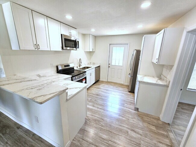 Building Photo - fully renovated 2-bedroom, 1-bathroom home with bonus guest room or office and oversized fenced yard