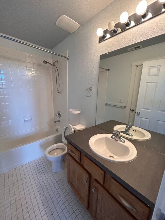 bathroom with access to 2nd bedroom and living area - 9921 E 26th Ave