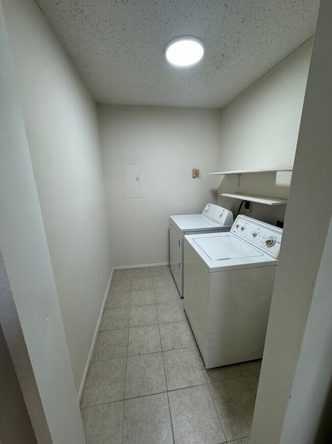 Laundry room and storage area. - 321 Thalia Station Ct