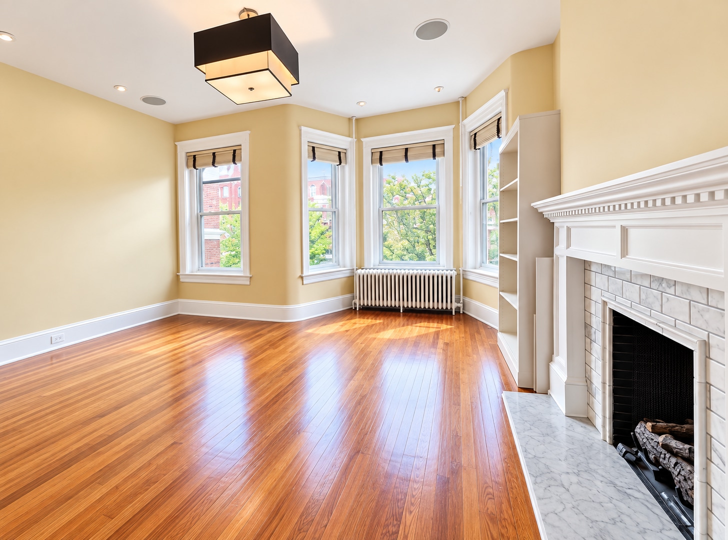 Bright bay window 2nd floor bedroom with hardwood floors and gas fireplace - 2322 1st St NW