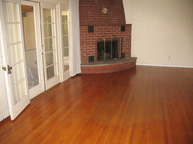 Living Room with magnificent brick fire place and mantle - 3121 W Wyoming Ave