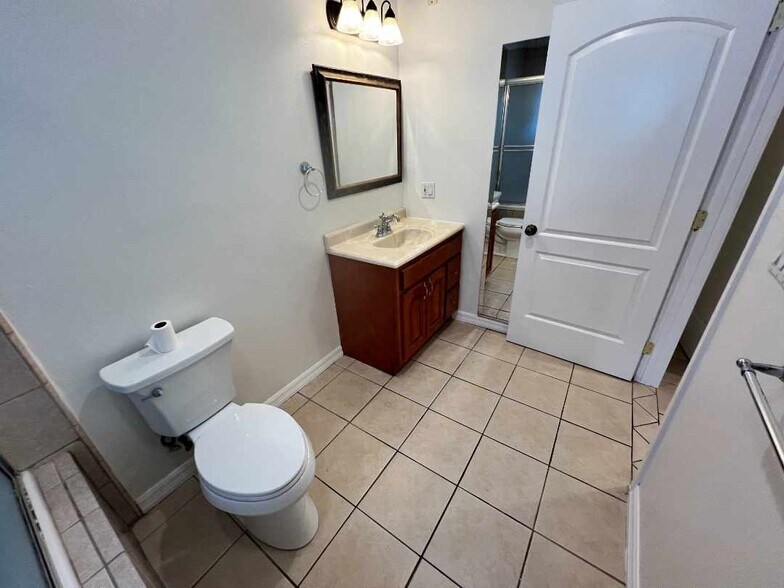 Primary bathroom (wide-angle) with single vanity. - 2330 S Mansfield Ave