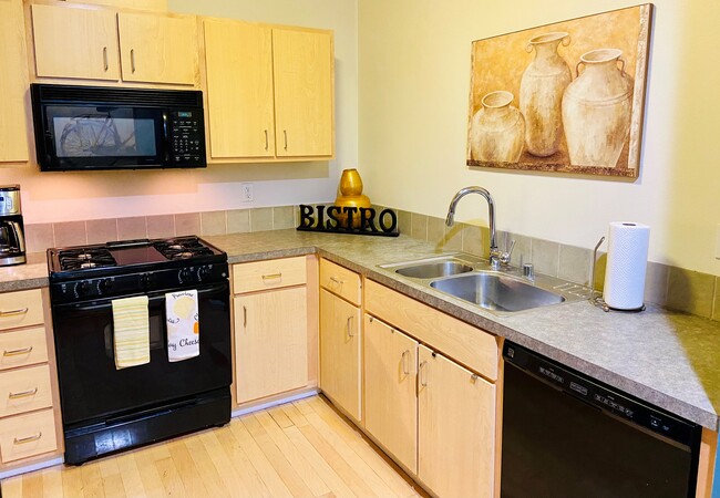 There is a fully equipped kitchen to make you feel right at home. - 2408 Main St