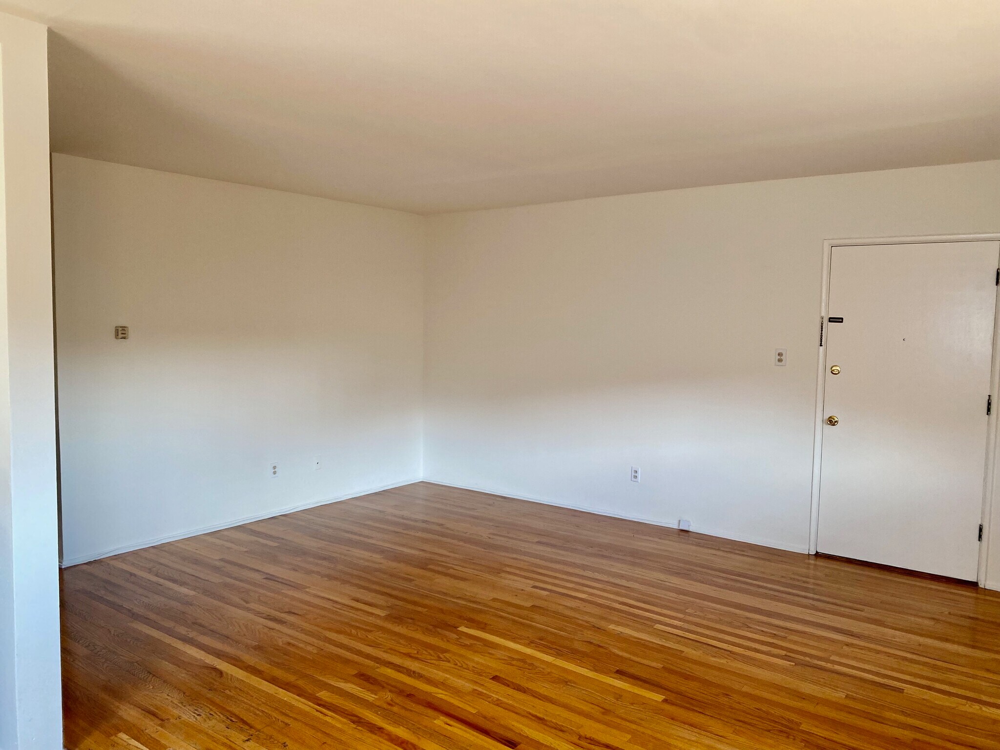 Living room with an A/C unit - 4039 Duquesne Ave