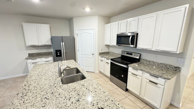 Building Photo - Available NOW! Spacious 4BD/2BA Haven in Villages at Harmony – Your Dream Home Awaits! WASHER & D...