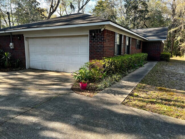 2 car garage, concrete driveway and sidewalk to entrance - 64 Island Dr