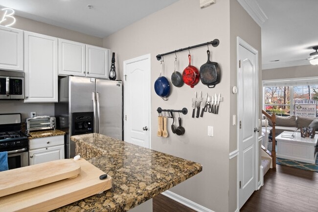 Building Photo - This inviting two-level townhome offers comfort and style, featuring gleaming hardwood floors on ...