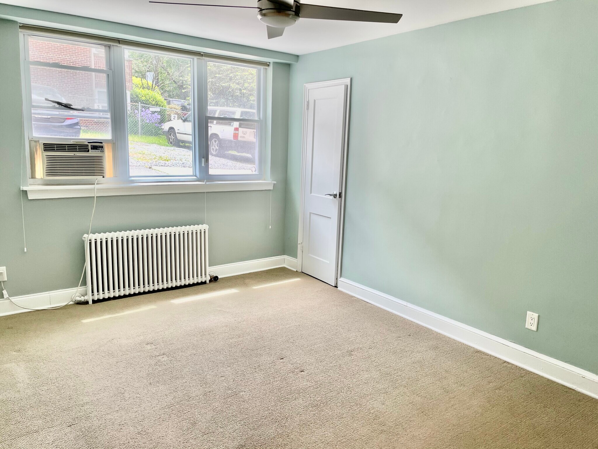 Bedroom with walk-in closet, carpet, and ceiling fan - 2339 40th Pl NW