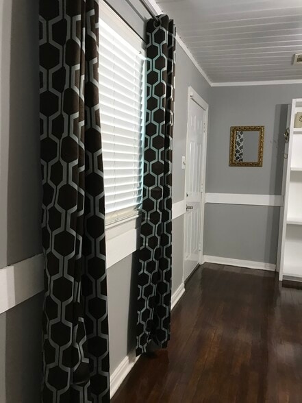 View across living room to front door and Entertainment Center - 1407 W Church St