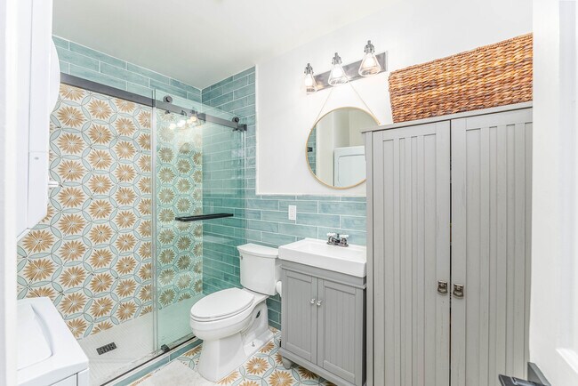 Bathroom with all new fixtures, tile and glass shower doors - 108 W Henry St