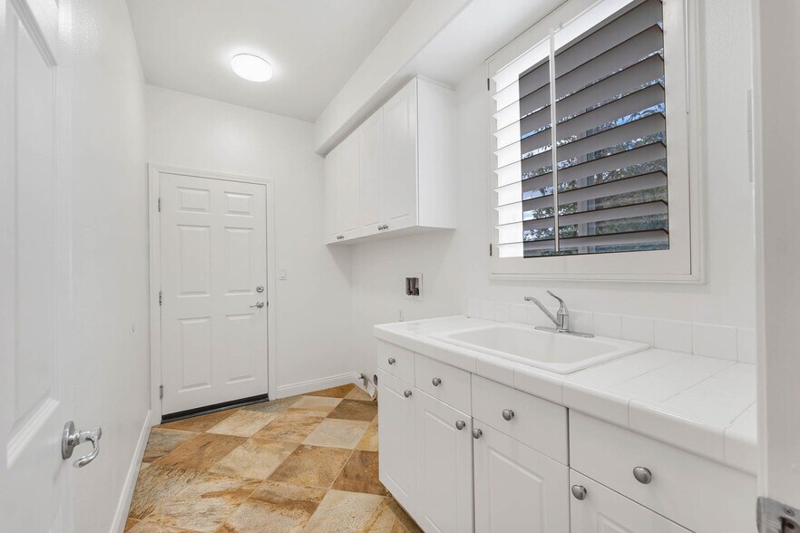 Laundry Room Adjacent To Kitchen With Door To Garage - 12215 Delante Ct