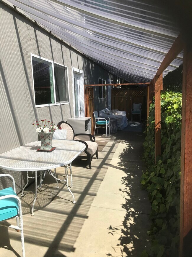 Patio with furniture on both sides. - 27 Graceland Dr