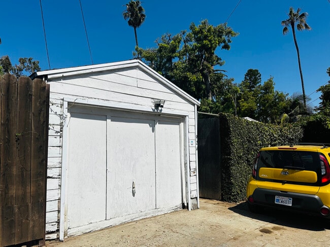 2-3 parking spaces behind the garage, with alley access & a secure gate & fence. - 924 Nowita Pl