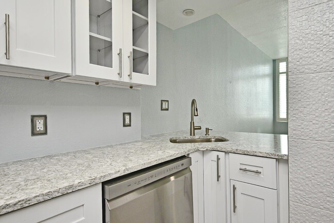 showing sink with opening looking toward LR and front windows - 400 E Colonial Dr