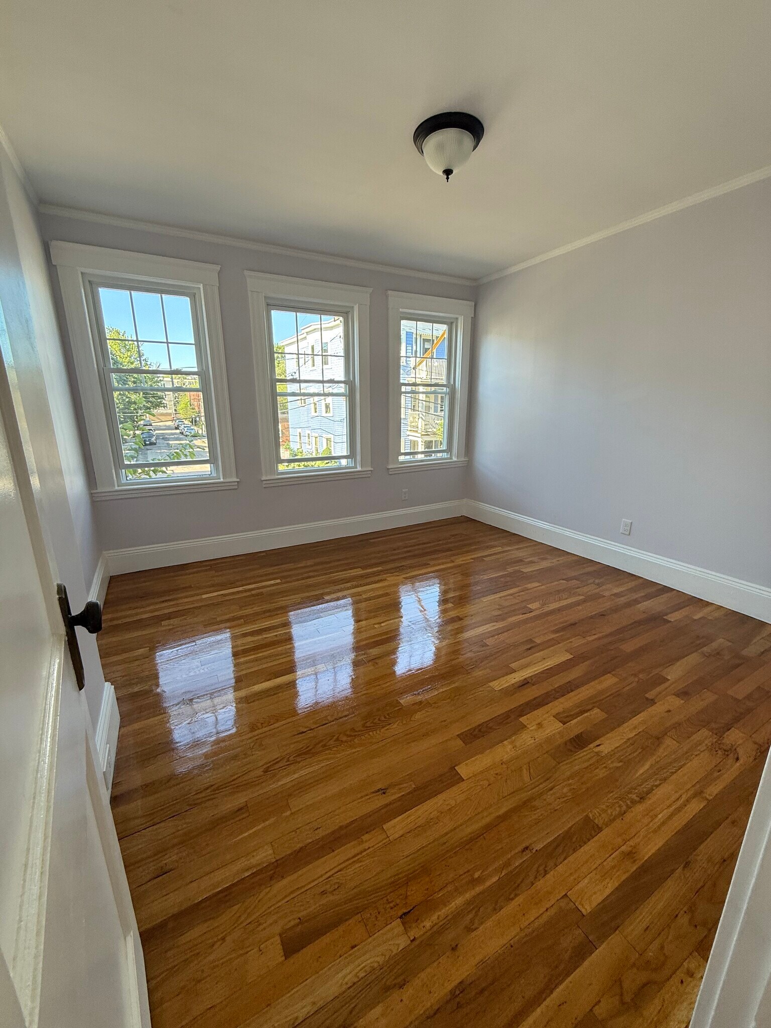 Front bedroom has 3 windows, closet, and ample space for a queen bed and desk - 27 Seven Pines Ave