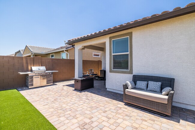 Rear yard with sitting area, fire table and and BBQ - 8924 W Solano Dr