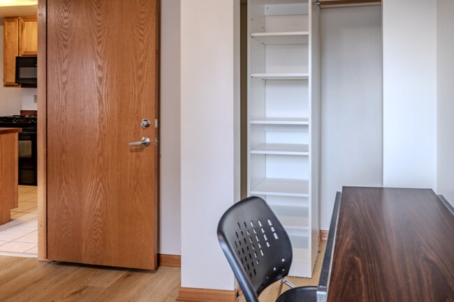 Bedroom with desk and storage - Varsity Campus Apartments