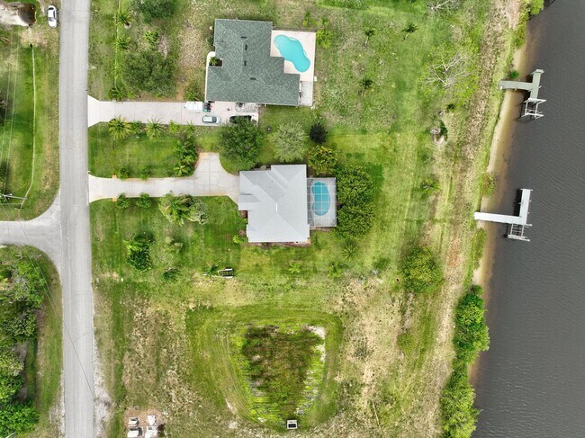 Building Photo - A BOATER'S PARADISE WITH THIS STUNNING 3 BEDROOM, 2 BATH WATERFRONT POOL HOME W/DOCK & BOAT LIFT ...