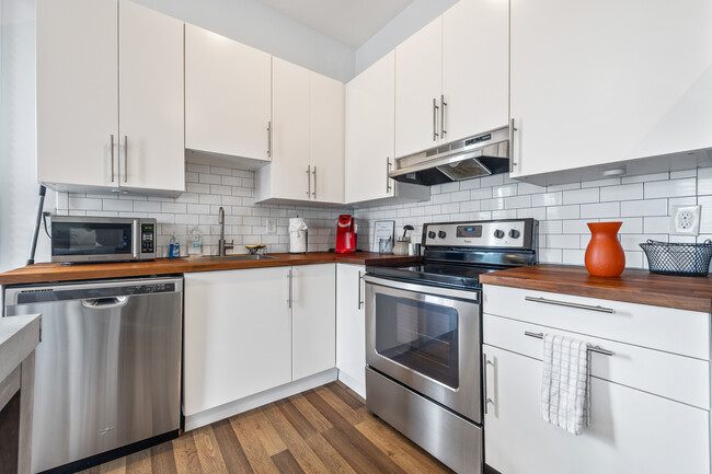 Kitchen is fully equipped with appliances including a large fridge, stove, and coffee station. It is - 906 Allene Ave SW