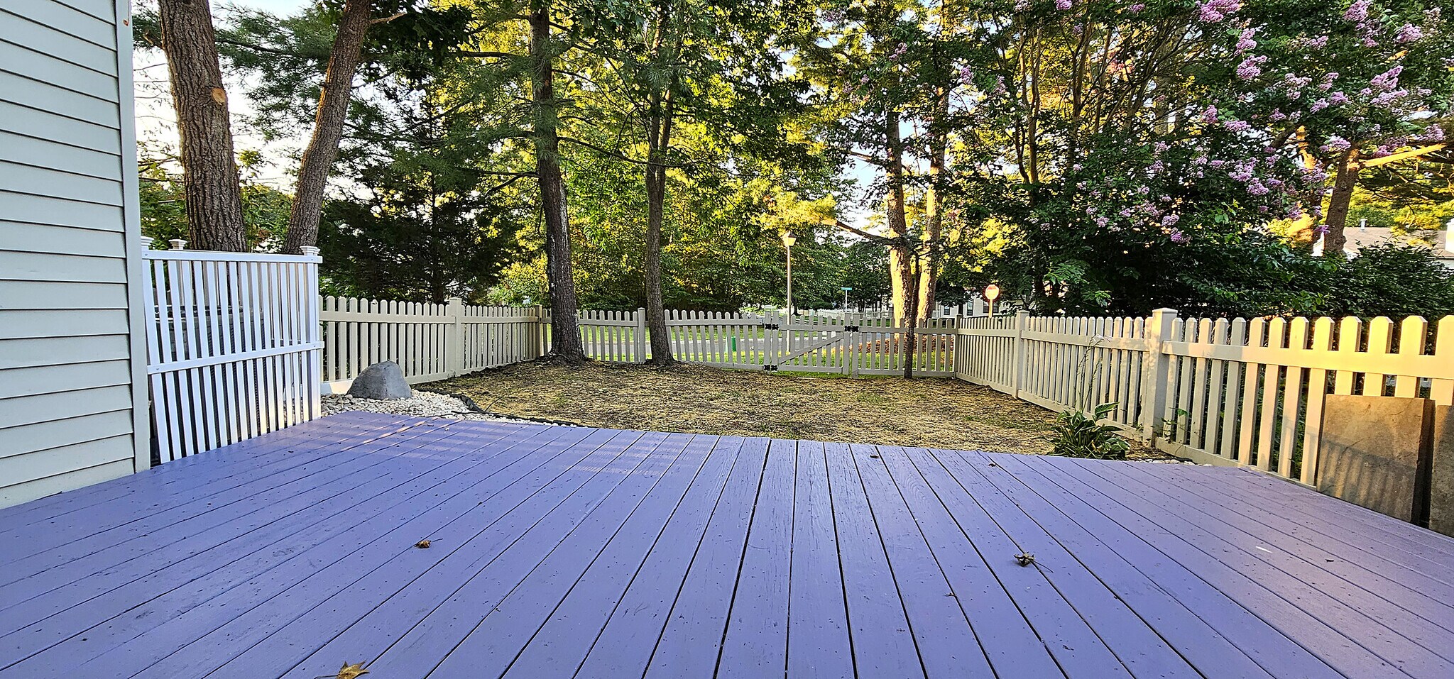 Fully Fenced Backyard | White picket-fenced rear yard backing to mature shade trees — fully enclosed - 43 Tynemouth Ct