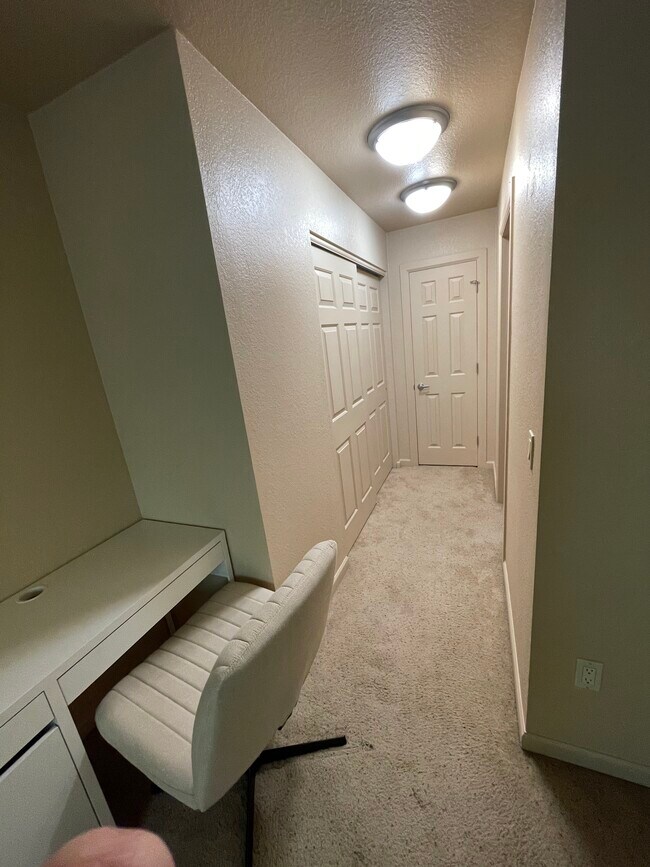 Master bedroom desk area and hallway to onsuite bath and 2 closets including linenw/ - 101 S Players Club Dr