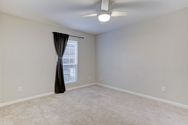 Large bedroom with brand new remote-control fan and walk-in closet - view without furniture. - 1880 White Oak Dr. Apt 119