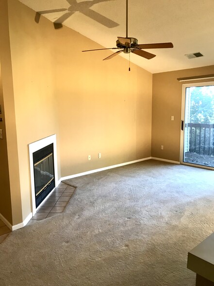 Main living area with gas fireplace and slider with deck - 3173 Windcrest Dr NE