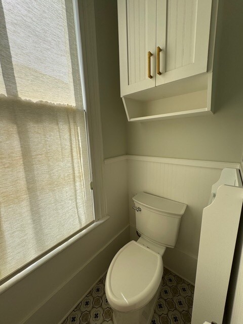 Toliet with overhead custom cabinetry - 1616 Post Office St