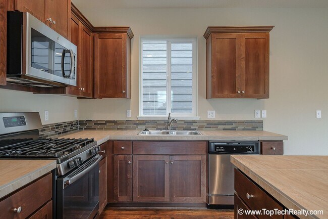 Building Photo - Spacious 4-Bedroom + Office Home in Abbey Creek – Modern Finishes, EV Charger & Low-Maintenance B...