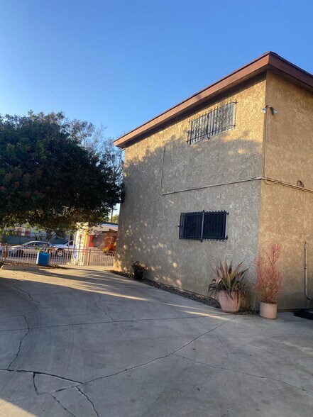 Parking lot/side view of building - 2458 S Normandie Ave