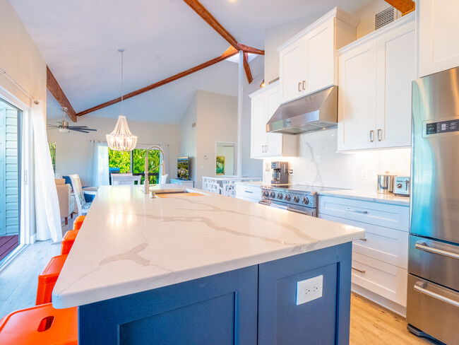 Huge kitchen island with seating. Kitchen deck to the left. - 3250 E De Bazan Ave