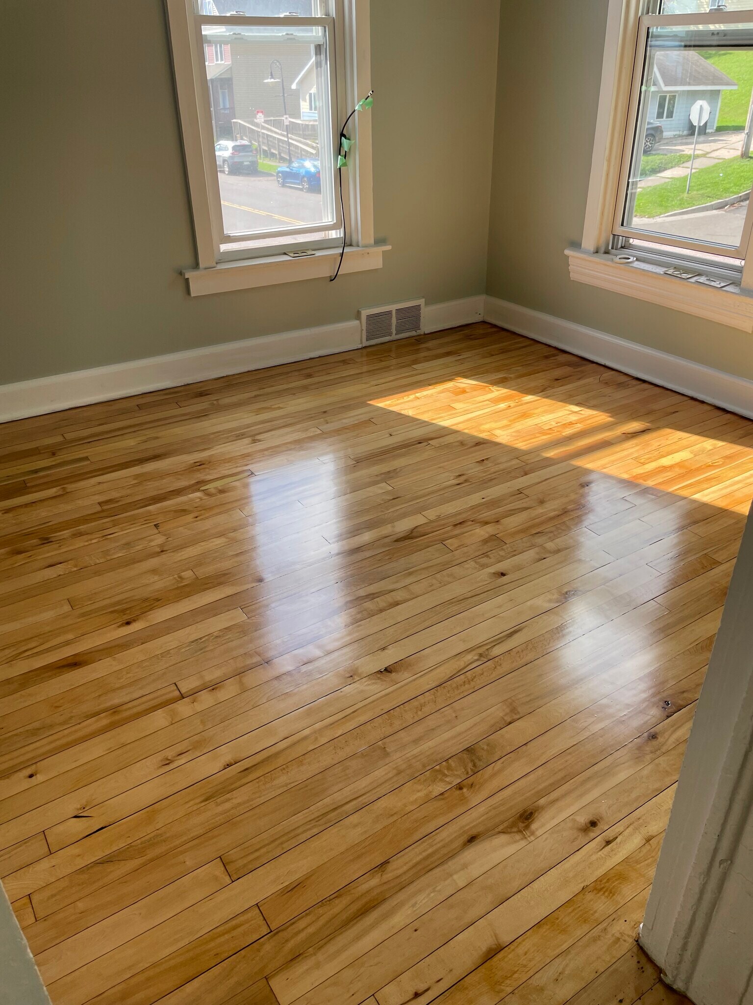 Newly refinished hardwood floors in the living room, two bedrooms and office - 204 E 4th St