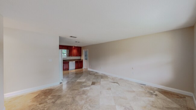 Building Photo - 3/2 with Den and extra long single car garage, huge fenced back yard