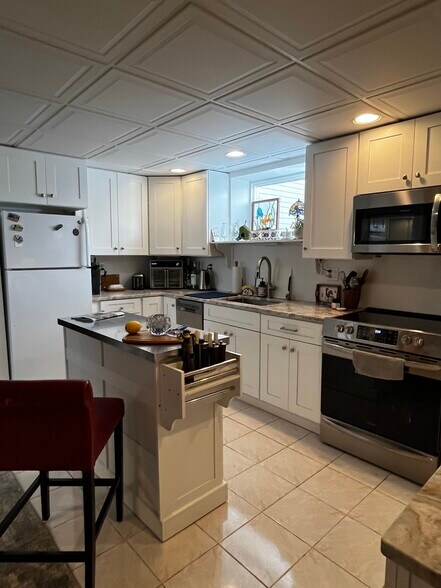Kitchen views, stove & DW & frig & island - 142R Page Rd