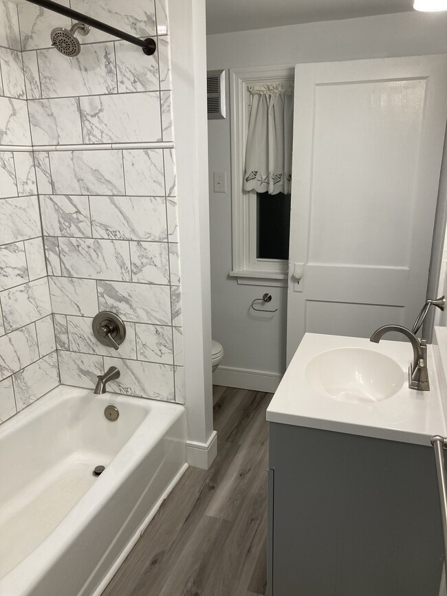 Renovated bathroom with new tub, sink, tile, and flooring! - 449 Brush Mountain Rd