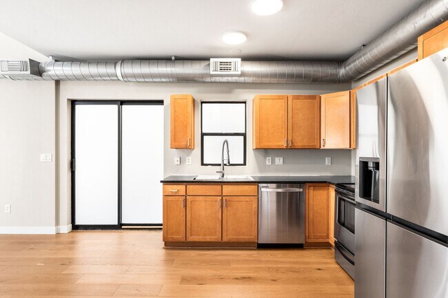 Building Photo - Modern 2BD, 1.5BA Condo with 20' Ceilings and Garage Parking Spot