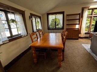 Dining table +6 chairs +3 extra chairs under Window plus hutch. - 2615 Parker St