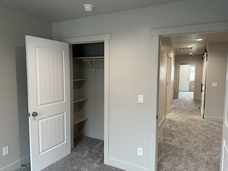 upstairs bedroom closet with shelves on both sides for easy sharing - 187 Courthouse Way