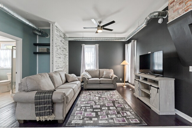 Sofa, loveseat, and TV in living area - 1110 W Grand Ave