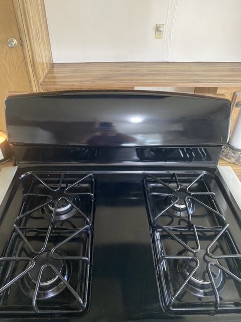 Stove is on a kitchen island - 16550 County Road 282