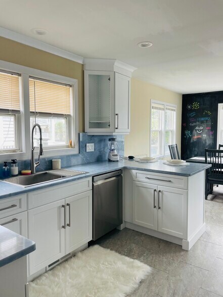 Kitchen with stainless sink and dishwasher /Bar/ Dining - 101 Lumina Ave N