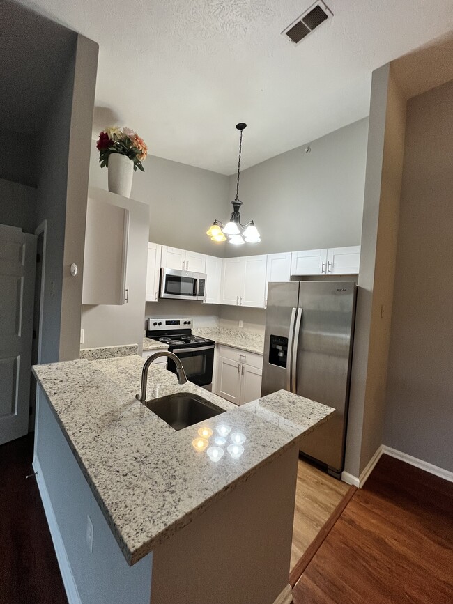 Updated kitchen with granite countertops and stainless steel appliances - 1208 Mist Wood Ct